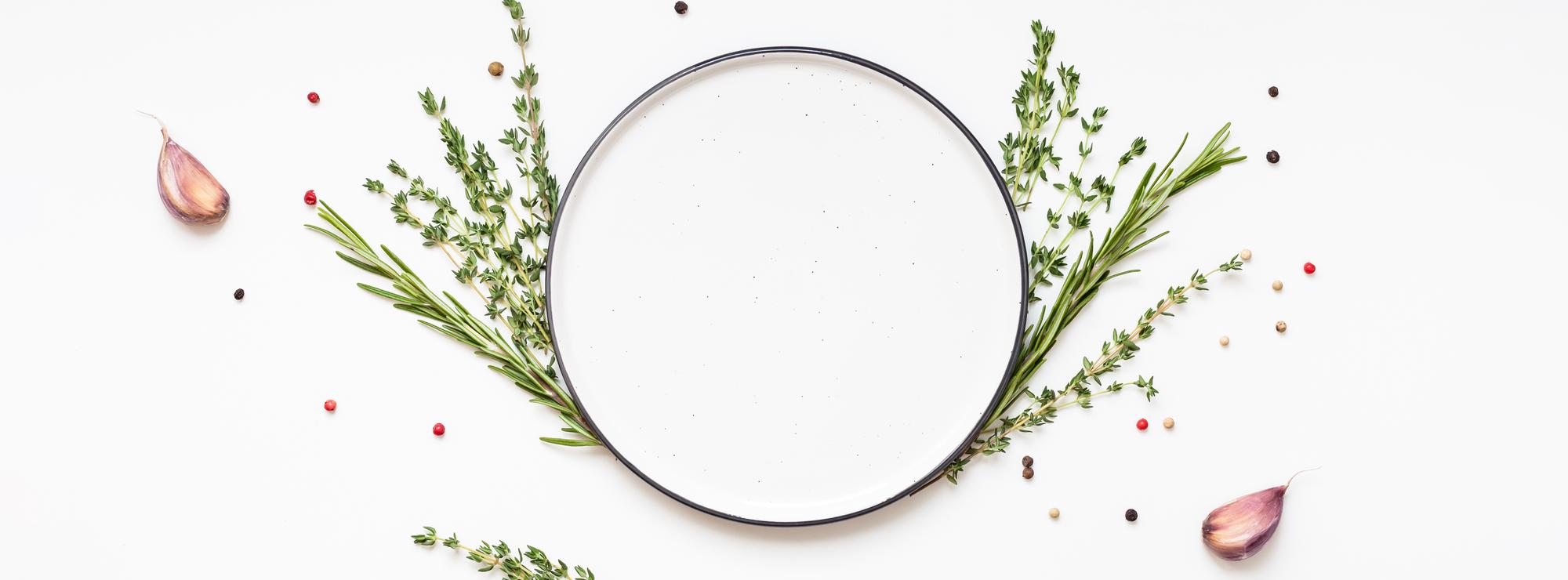 Overhead of plated seasonal menu with herbs